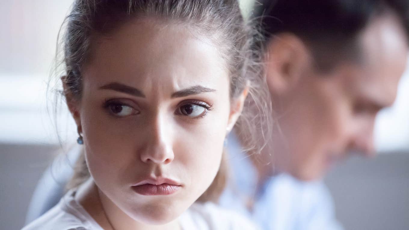Three Signs You're Dealing With Someone Emotionally Unavailable woman looking away from partner