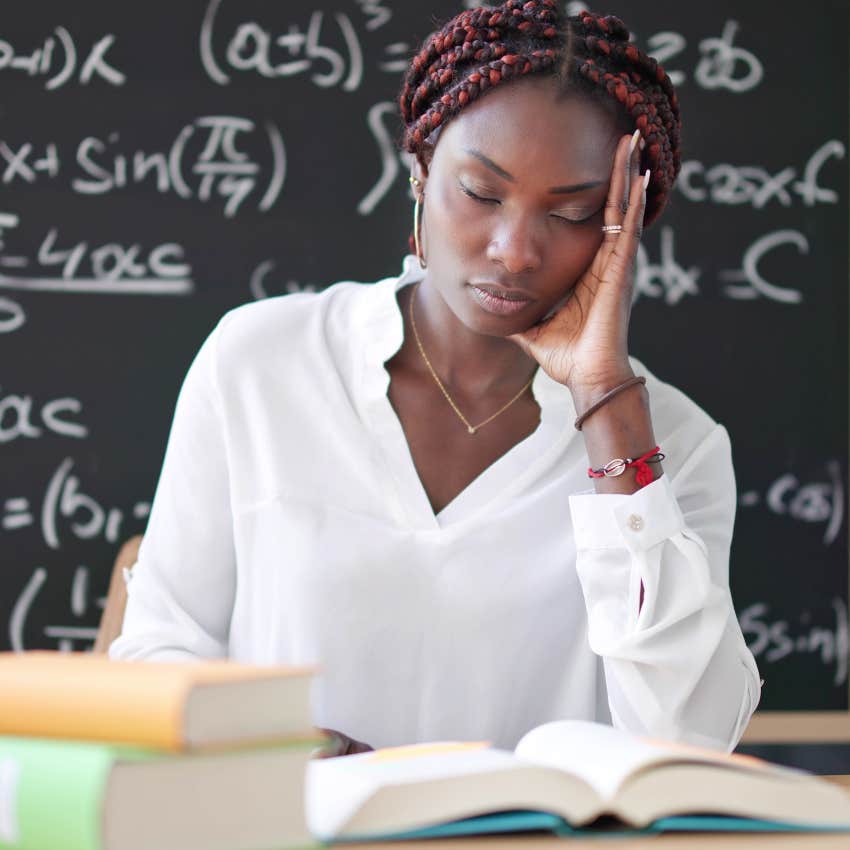 Teacher looking tired at her desk. 
