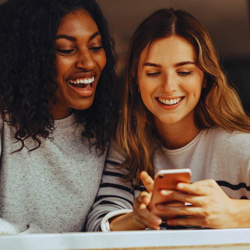 two friends looking at a phone