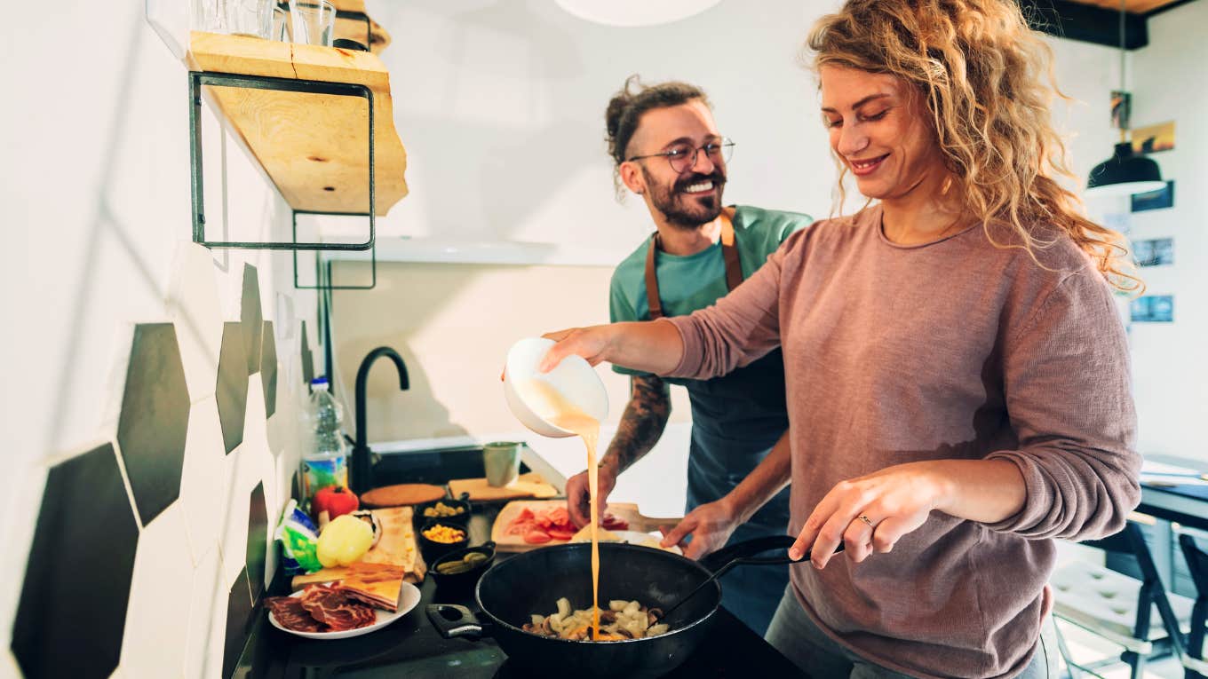 Happy marriage in midlife, couple talking while cooking 