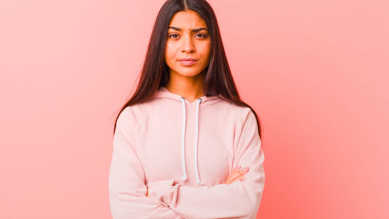 young woman with arms folded