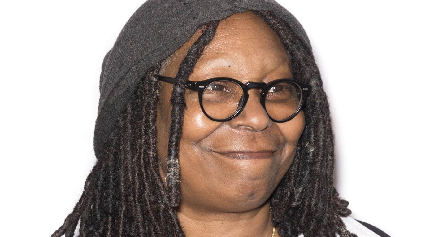 Whoopi Goldberg wearing glasses and hat