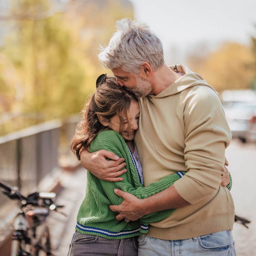 Teenage daughter hugging her father