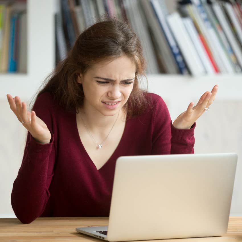 Woman upset reading email from boss