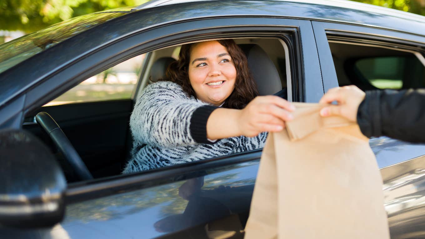 Woman Orders Kids' Meals Because It's Cheaper Than Buying Groceries woman getting food from the drive thru