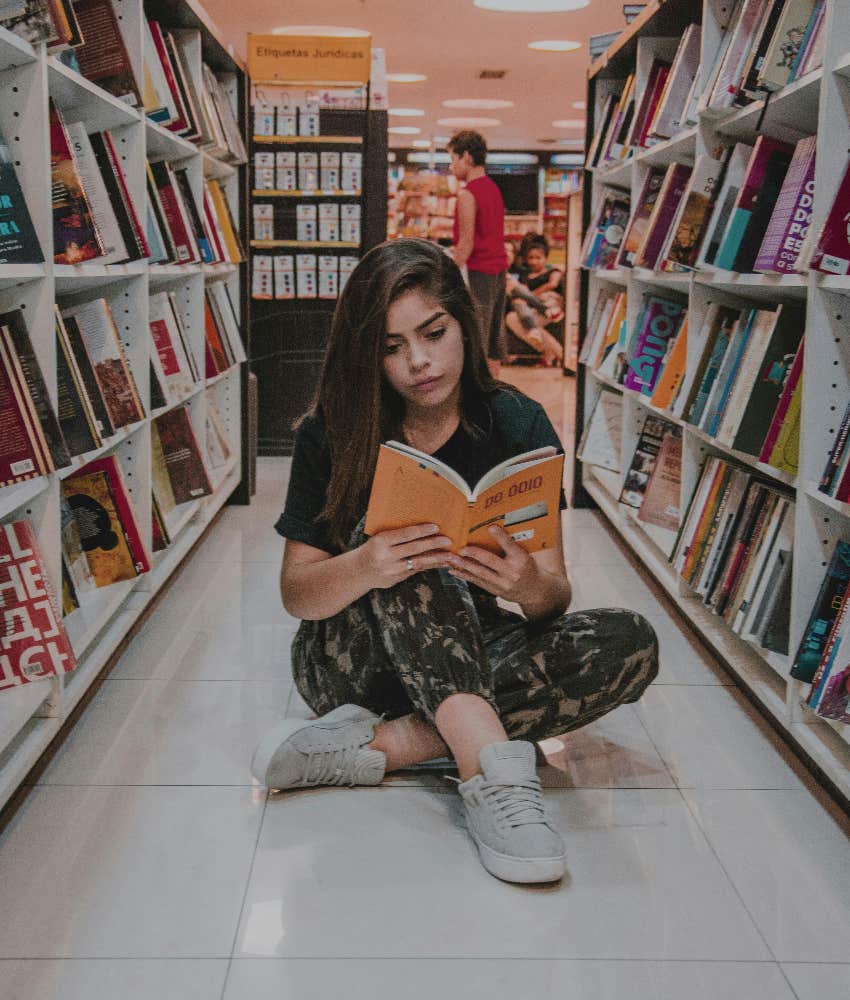 intelligent woman reading books in a library