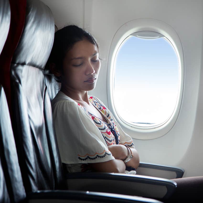 Woman asleep on plane