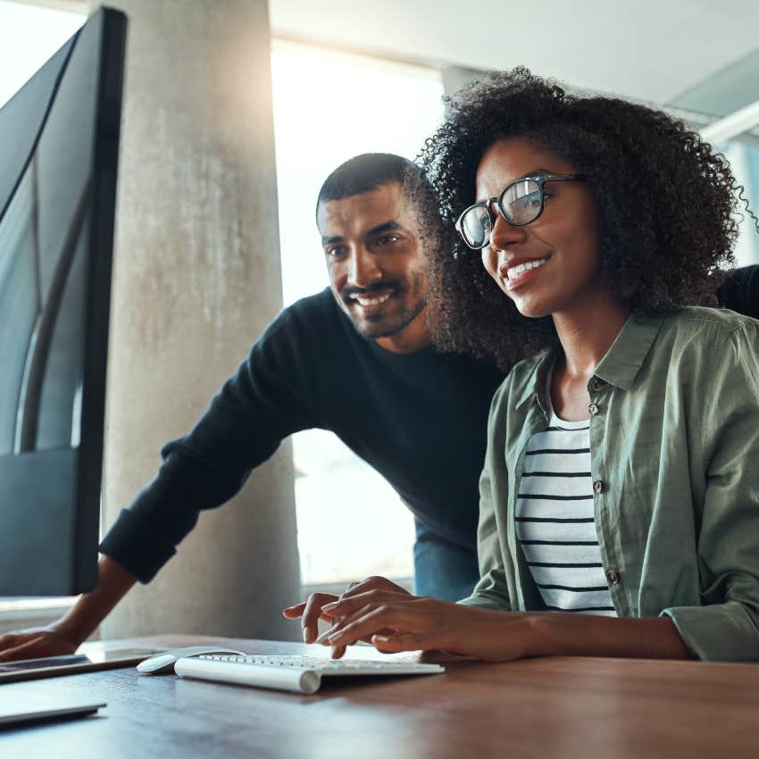 Two professional business people working together in office