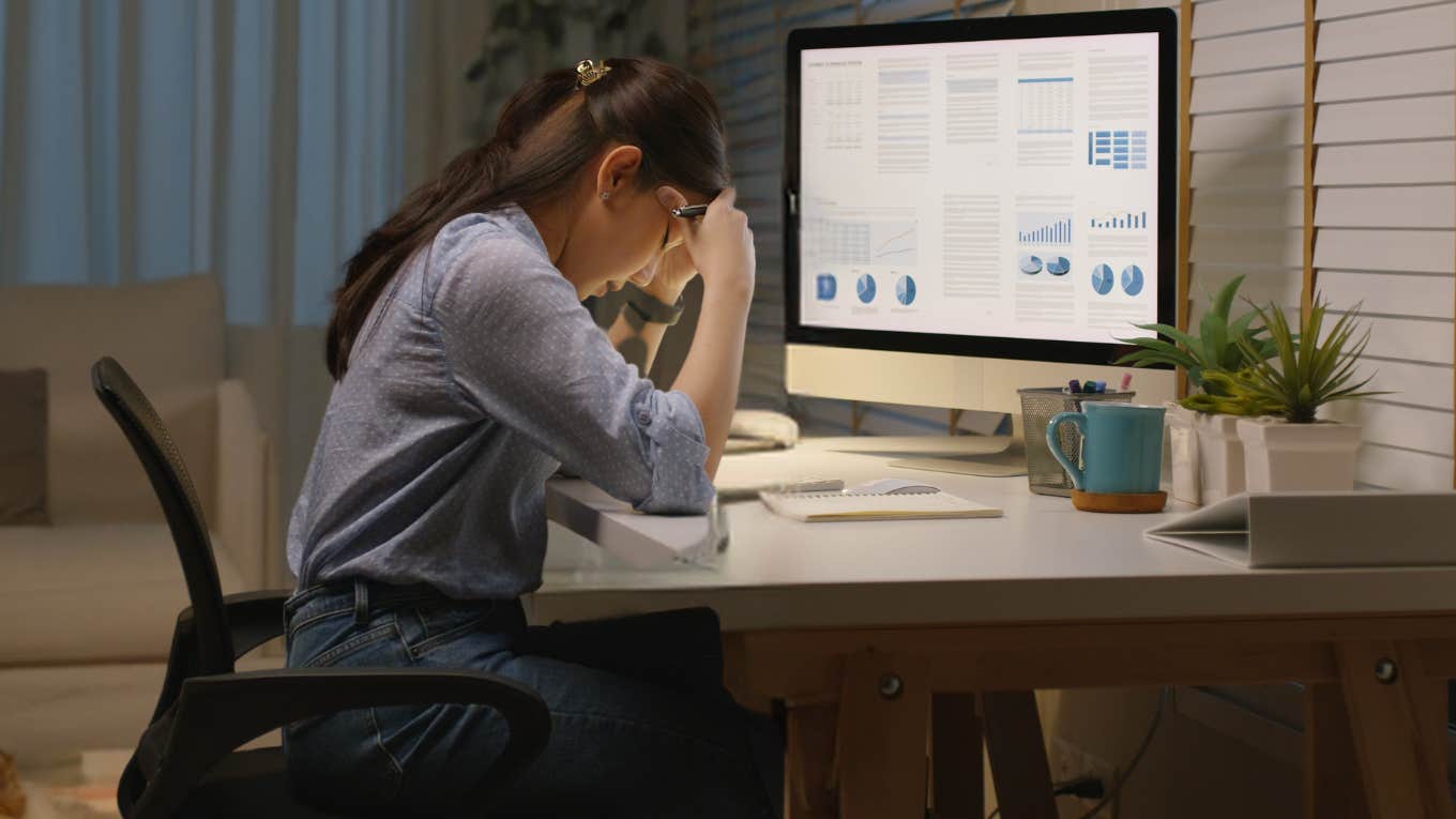 Woman Told She’s Not ‘Cut Out For Corporate’ After Not Working Nights & Weekends Corporate employee frustrated while working on laptop.