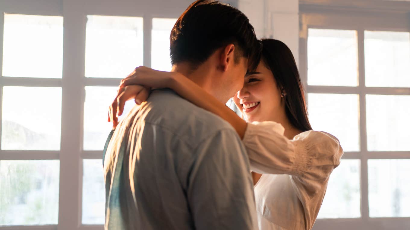 Woman Wonders If She Should Stop Talking To Man Online Because He's Poor Young couples hugging and smiling.