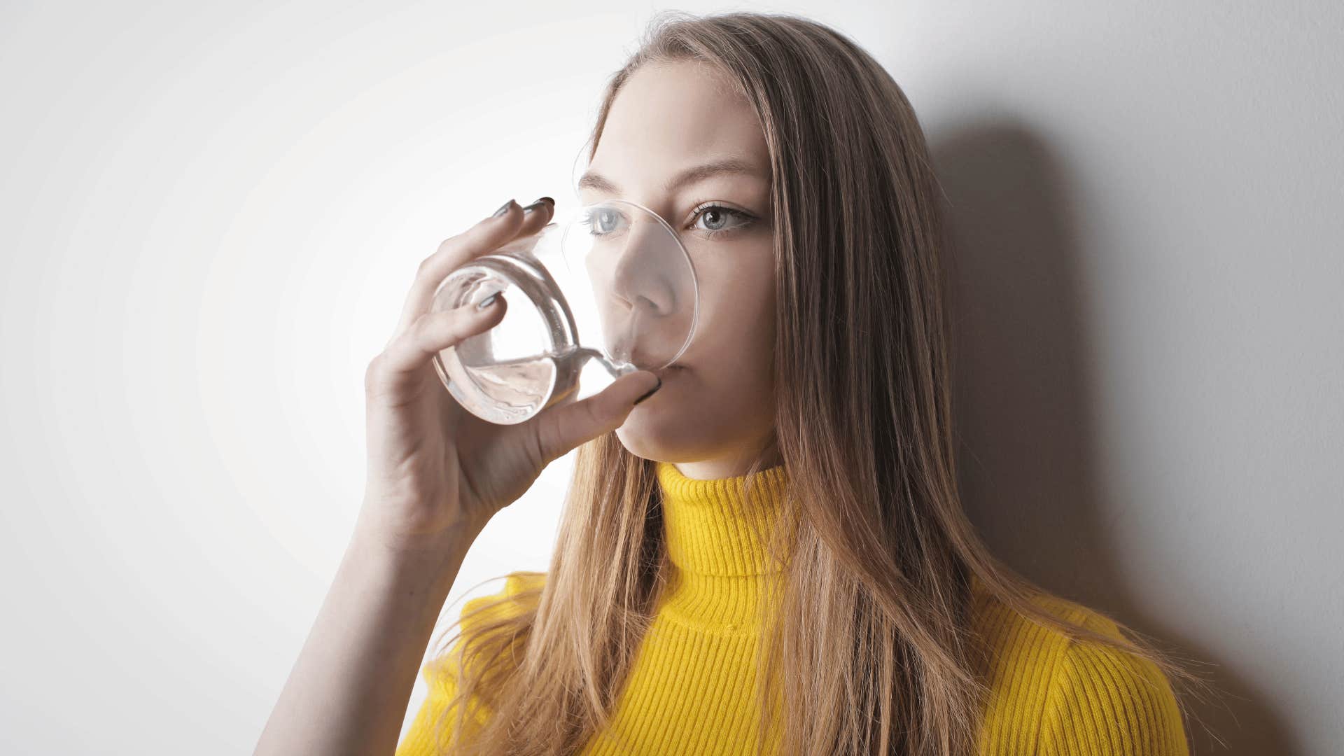 woman drinking water to fast