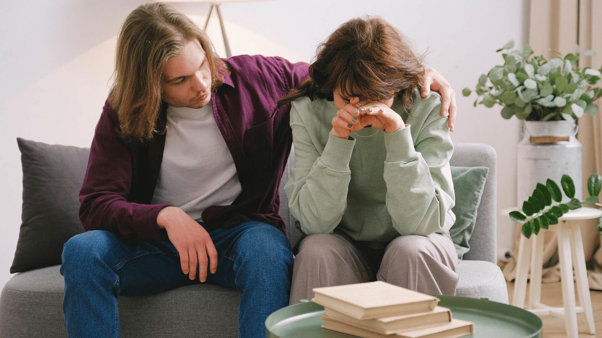 man comforting crying woman