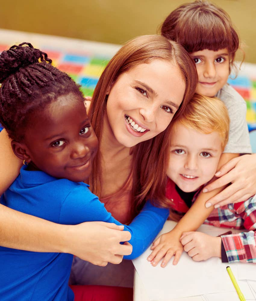 teen daycare volunteer hugging kids