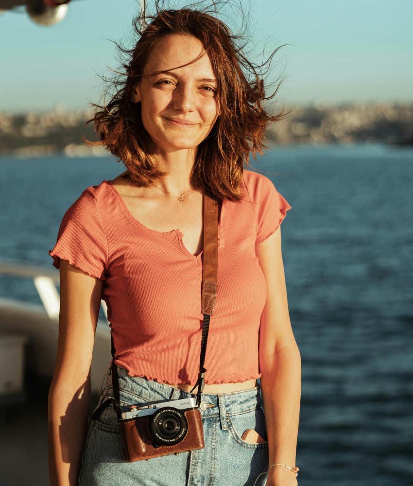 woman with camera at beach 