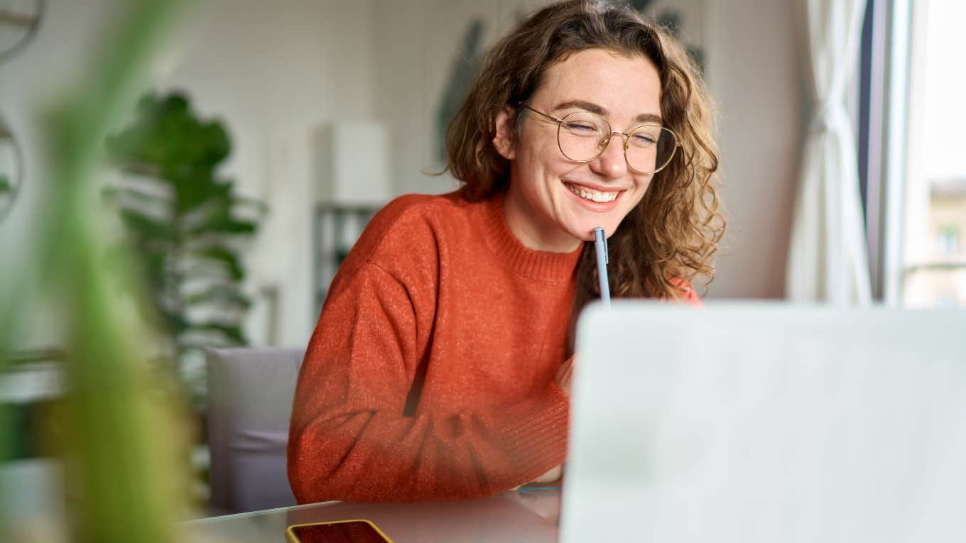 Gen Z Worker Says Her ‘Lazy Girl Job’ Is Only 2 to 3 Hours Of Real Work A Day Gen Z employee working her "lazy girl job" at her laptop.