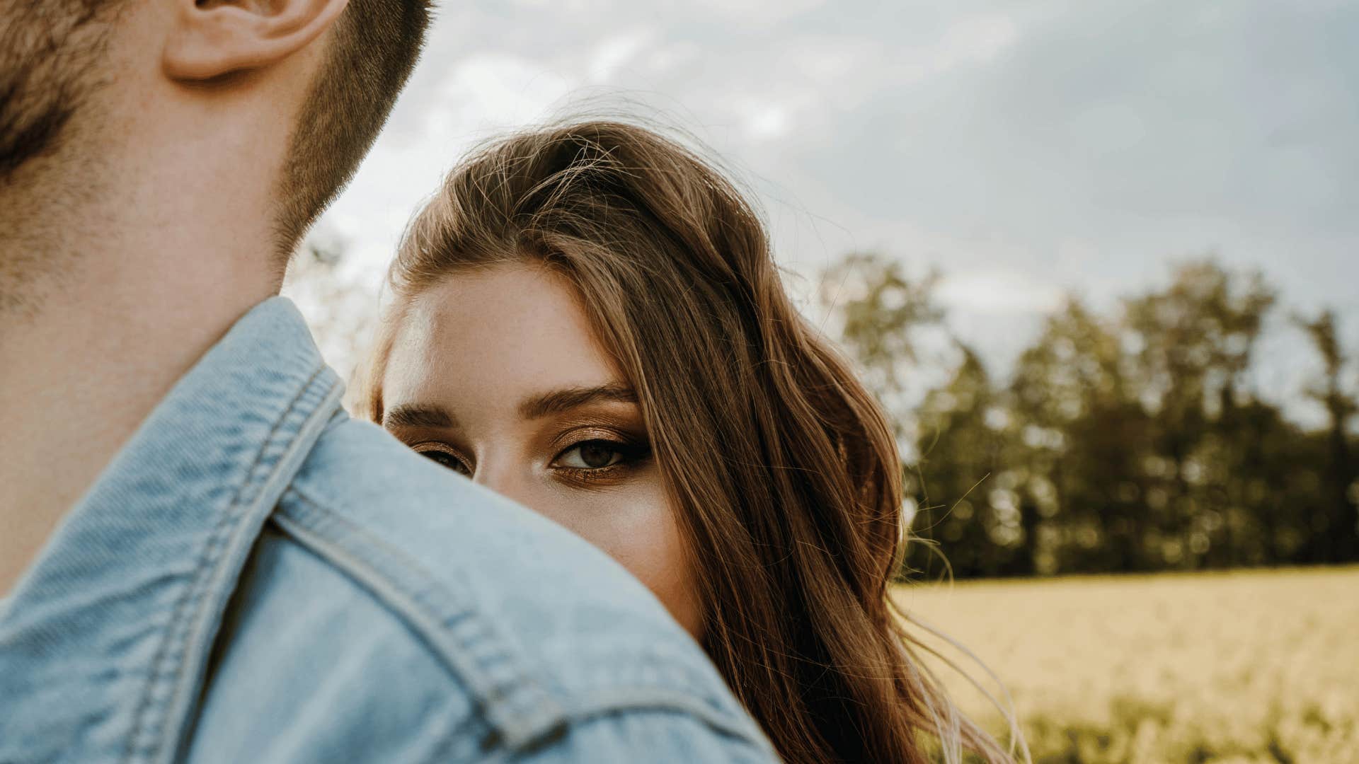 woman standing behind a man