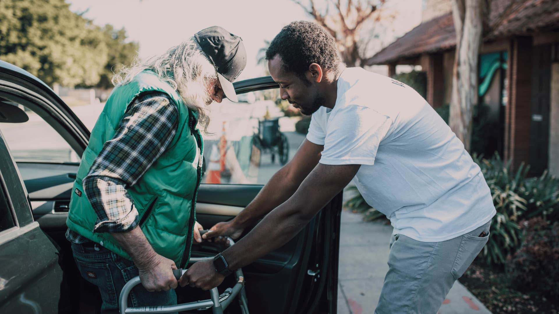 man helping older gentleman