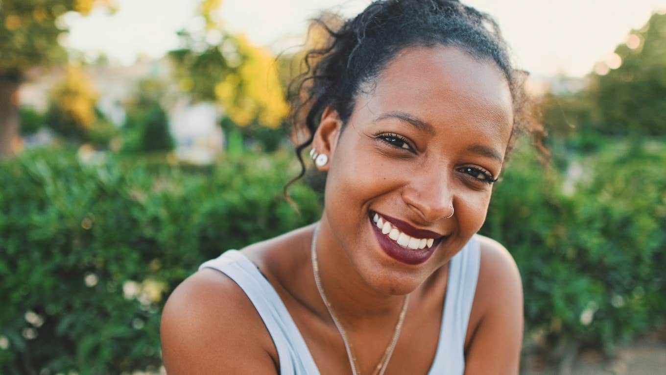 People With The Most Fulfilling Lives Follow 7 'Golden Rules' smiling woman following golden rules of happiness