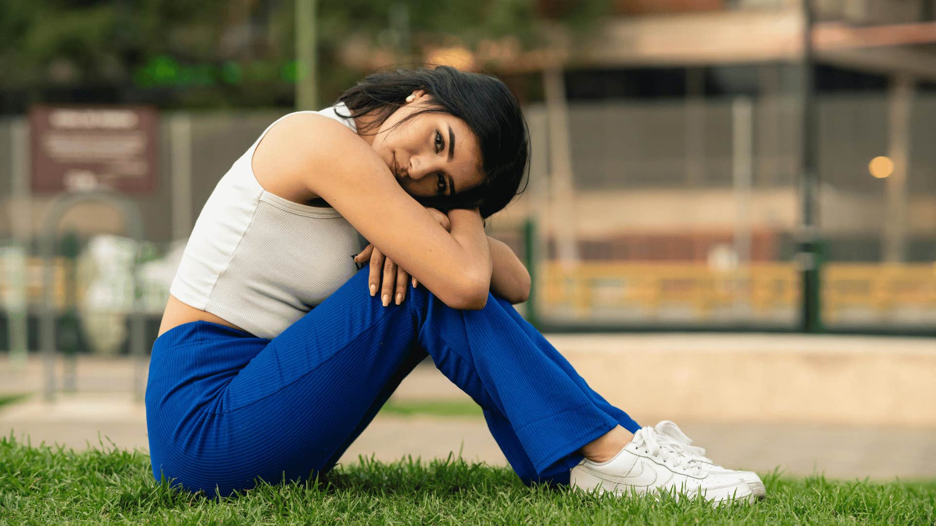 woman sitting on grass thinking