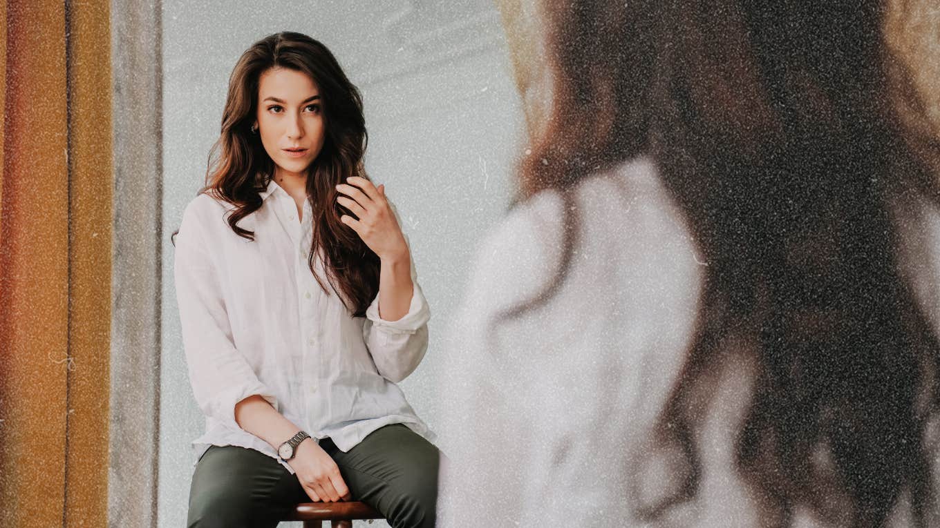 The Biological Reason We Feel How We Do When Looking In The Mirror Woman looking in mirror judging herself, biological reason we do so