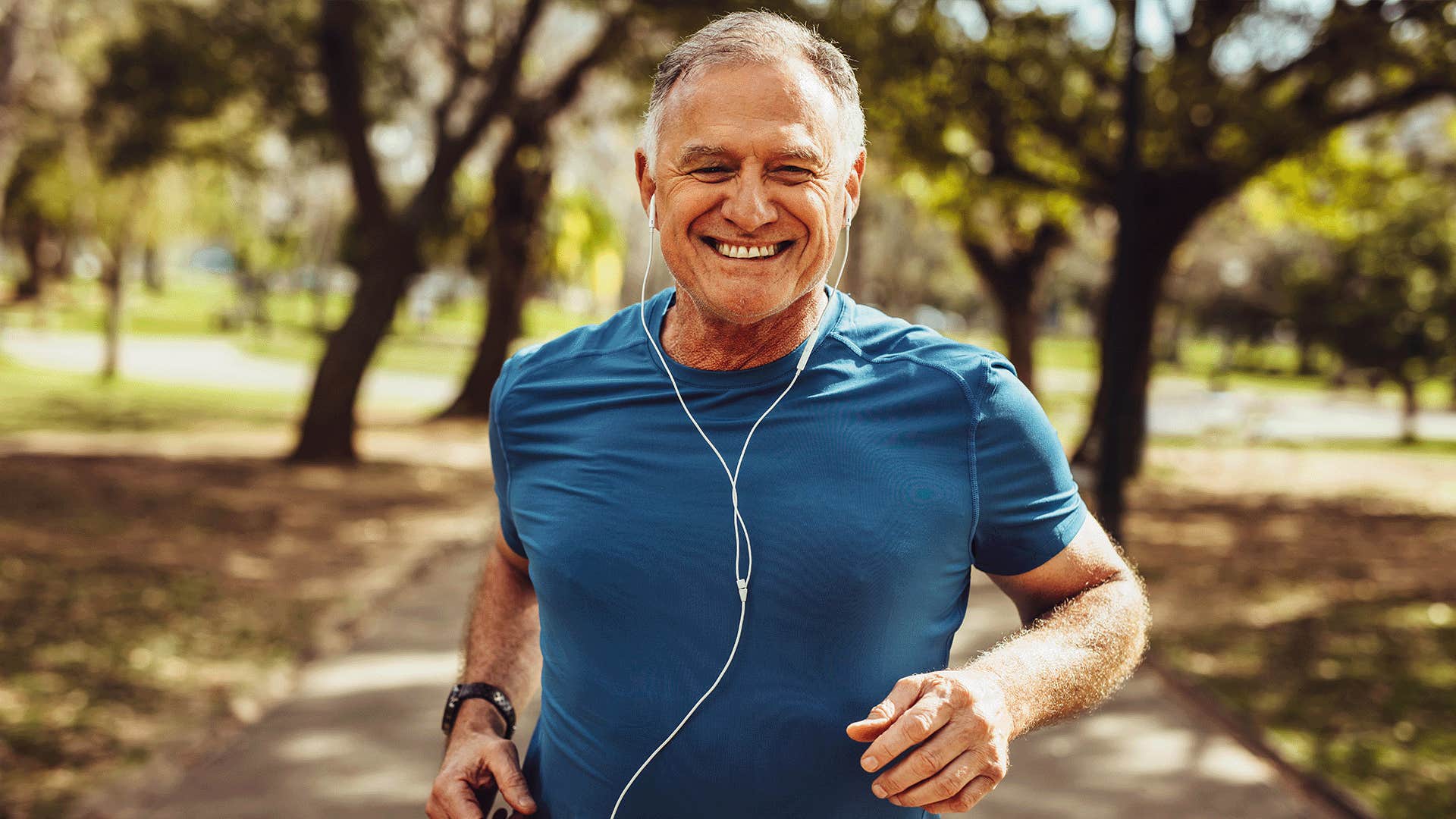 happy older man running in the park
