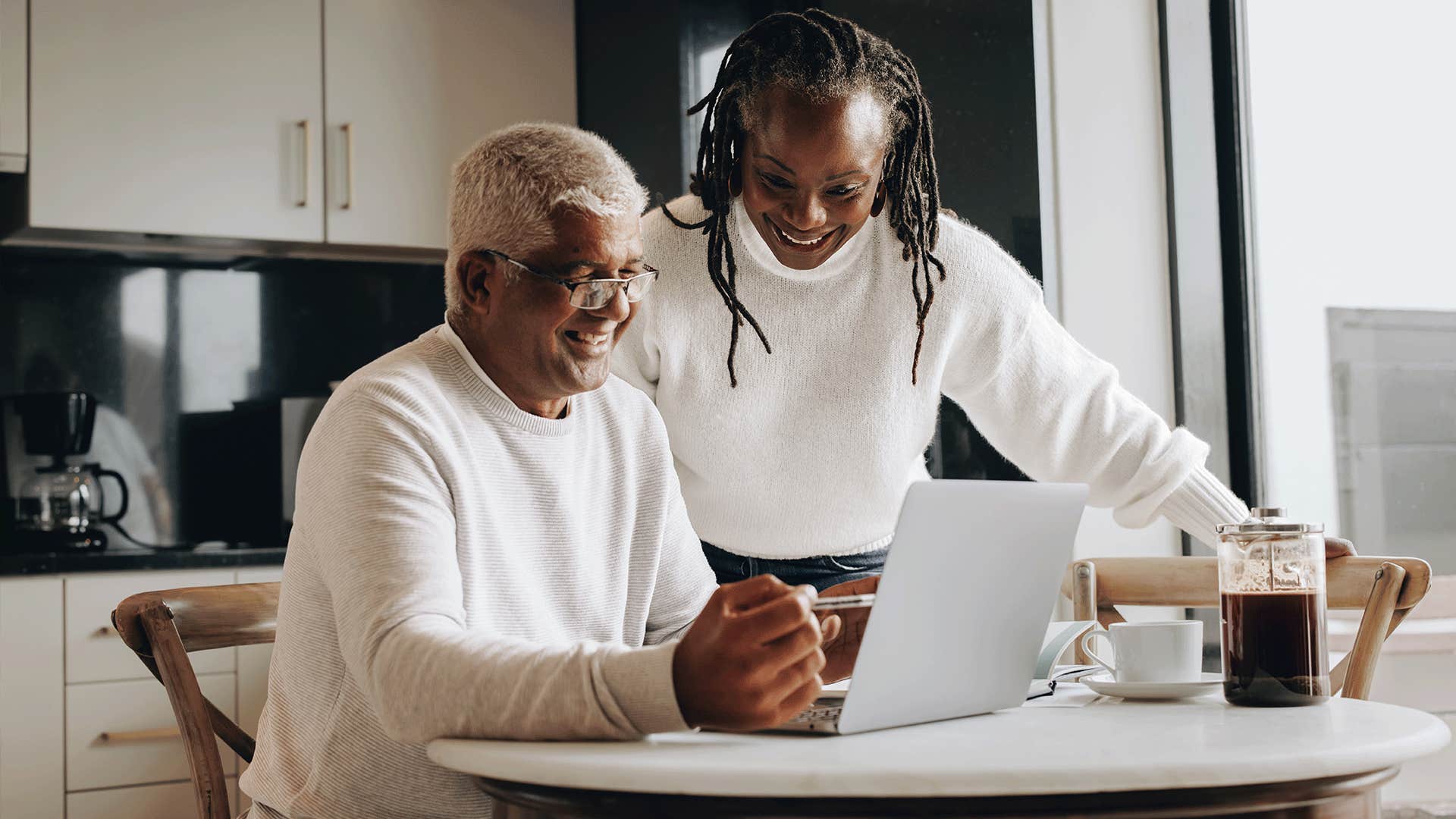 older black couple talking together in the kitchen