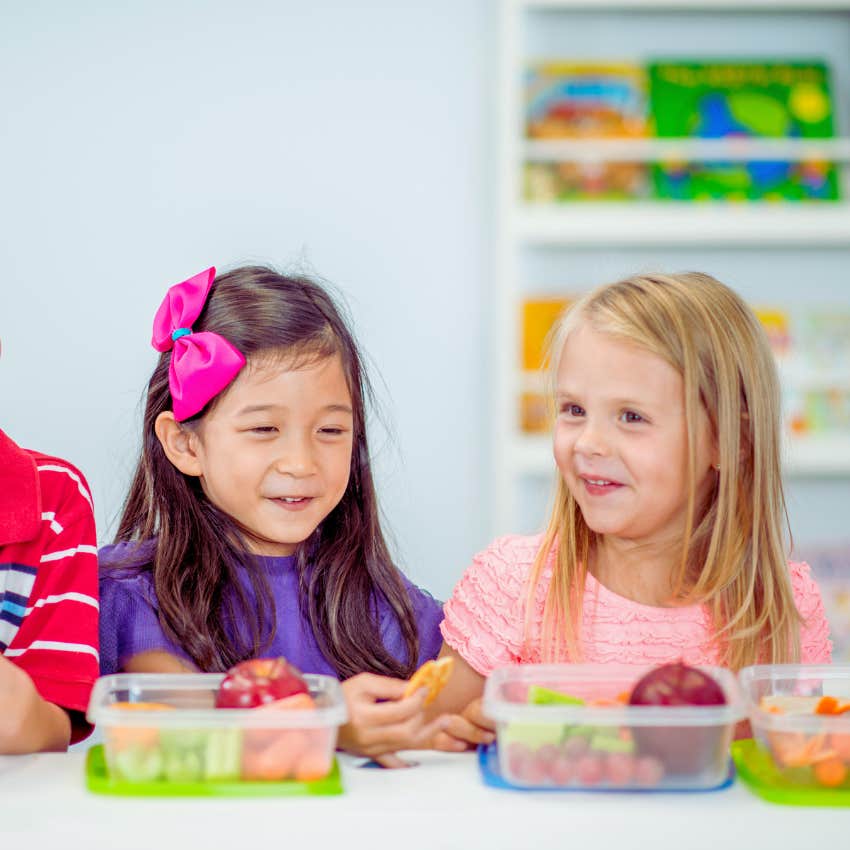 two little girls eating lunch at school