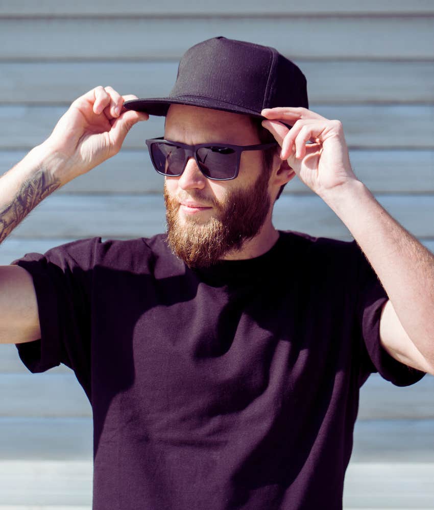 man in sunglasses wearing black baseball hat