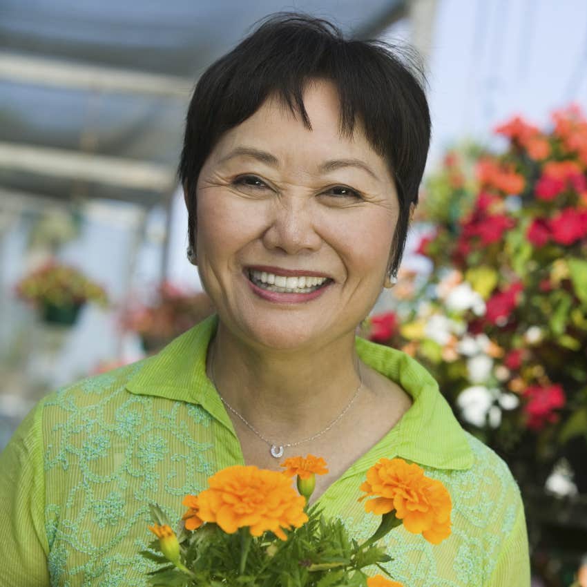 older woman holding flowers