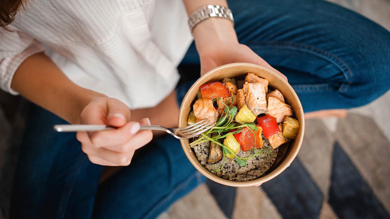 Mom Creates Diet Plan For Whole Family Based On -Year-Old's Needs woman sitting cross legged holding a bowl of healthy food