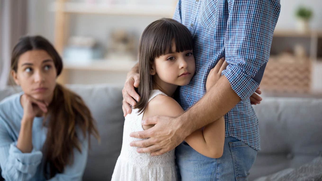 Mom Faces Criticism For Saying She Won By Giving Up Custody Of Her Daughter mom watching young girl hug her father