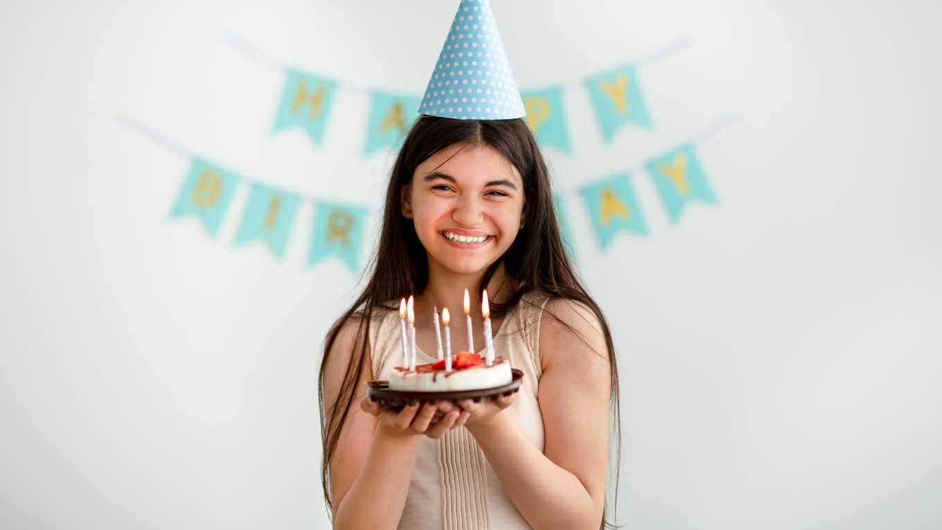 Mom Mad At Ex For Not 'Covering' For Her When She Forgets Daughter's Birthday young girl holding cake in front of happy birthday sign