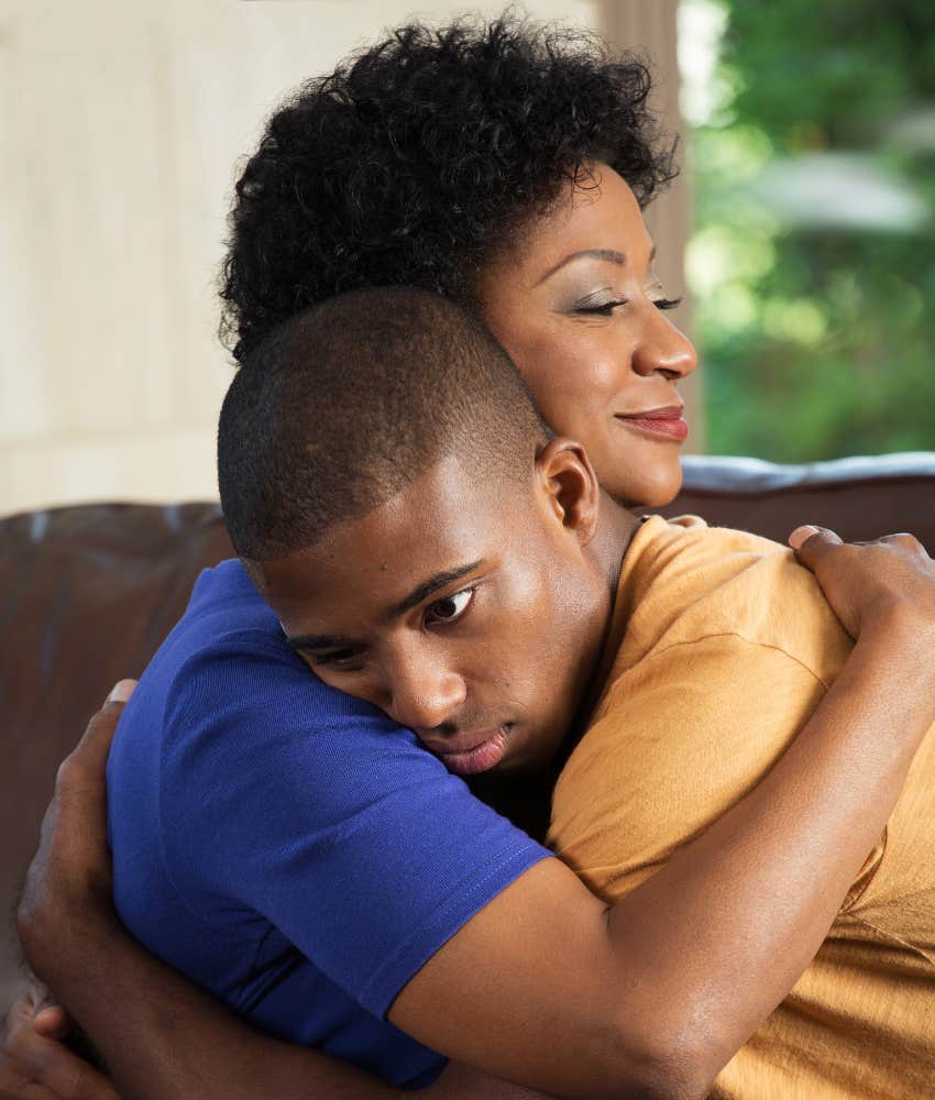 mom and teen son hugging
