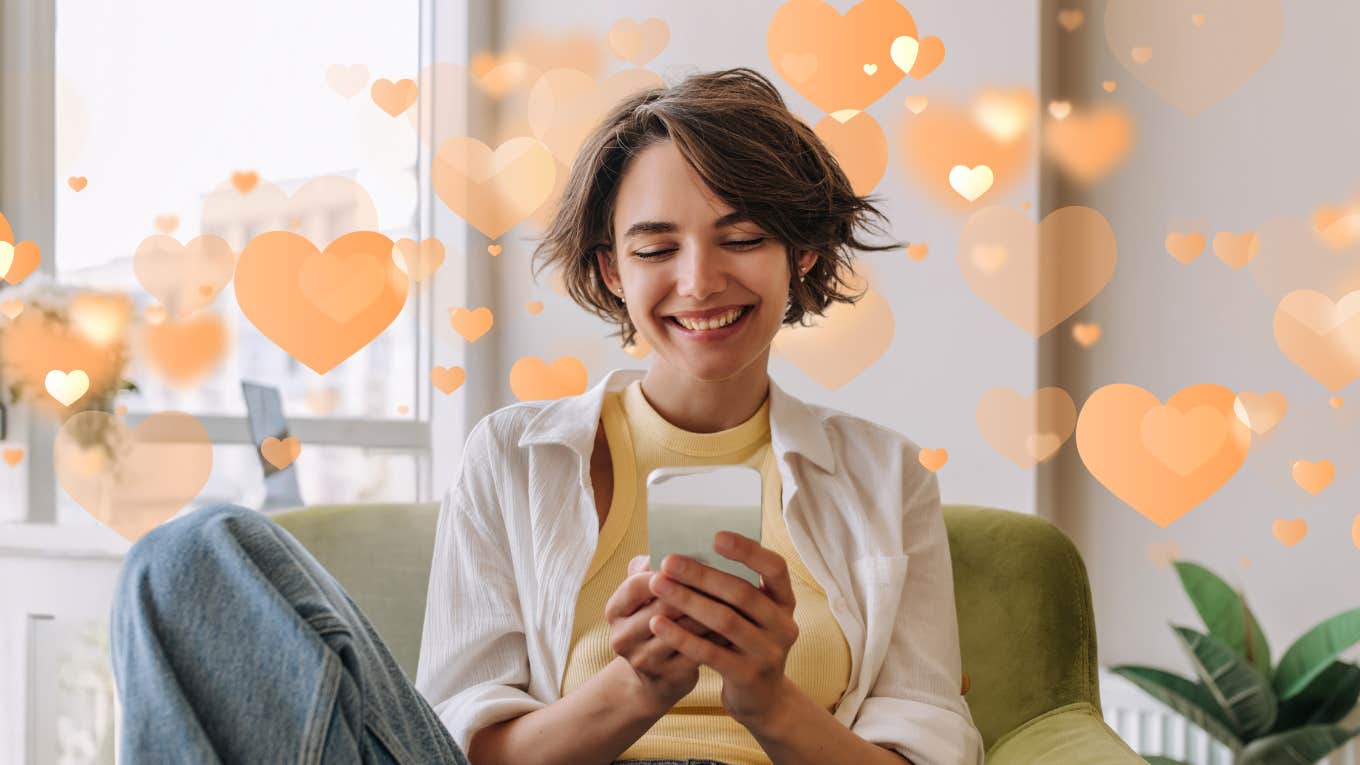 Woman with short brown hair smiling at the text message that means the most to her