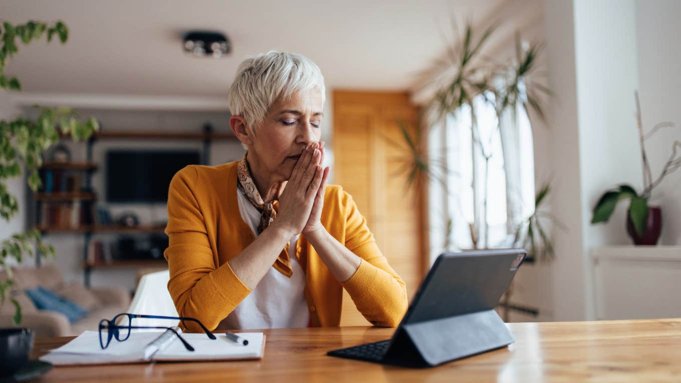 The One Phrase To Say Out Loud That Can Help You Separate Yourself From Strong Emotions woman tries to release negative emotions from energy