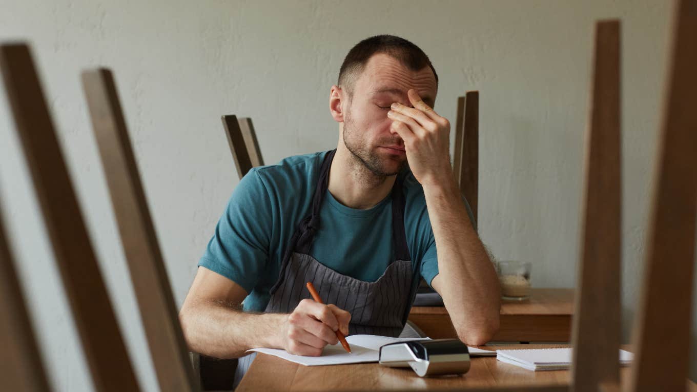 Restaurant Server Says He Wasn't Allowed A Single Break During A 9-Hour Shift exhausted young man calculating finances and doing inventory at small business shop
