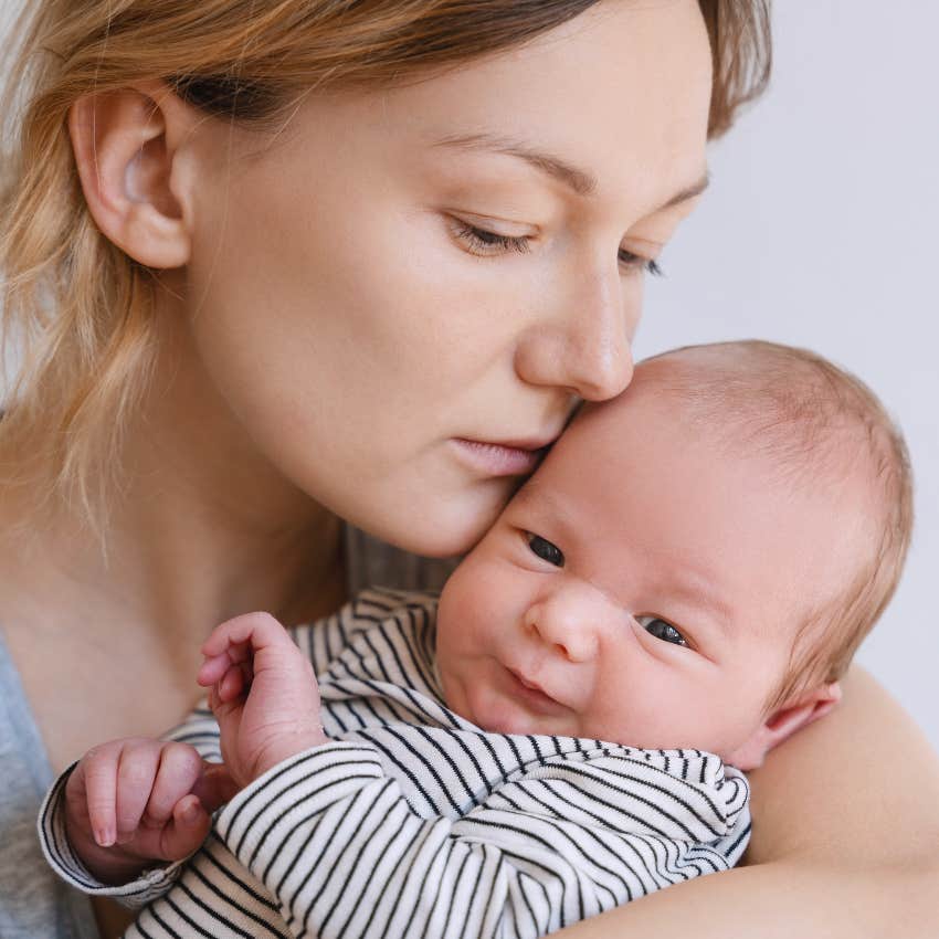 sad new mom holding her baby