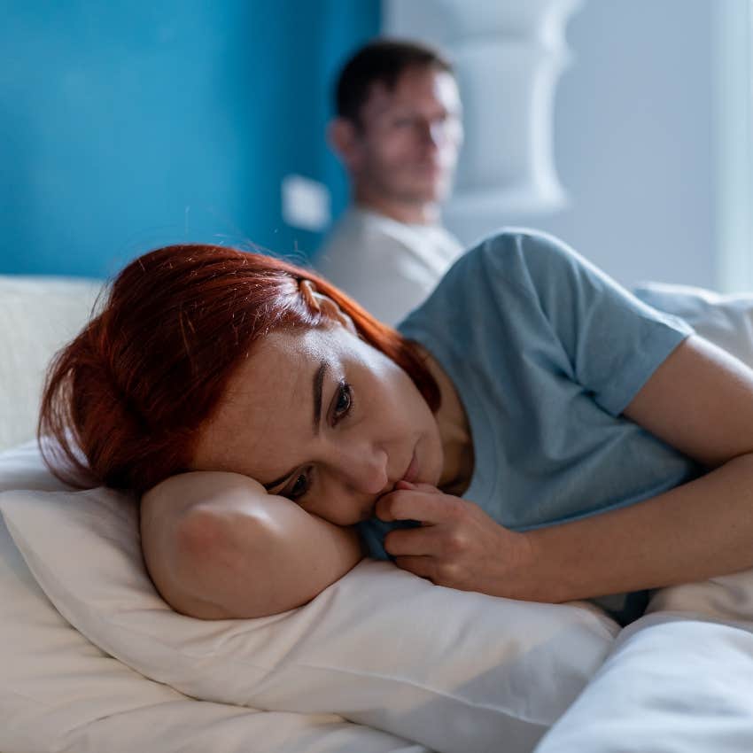 Sad woman in bed with husband