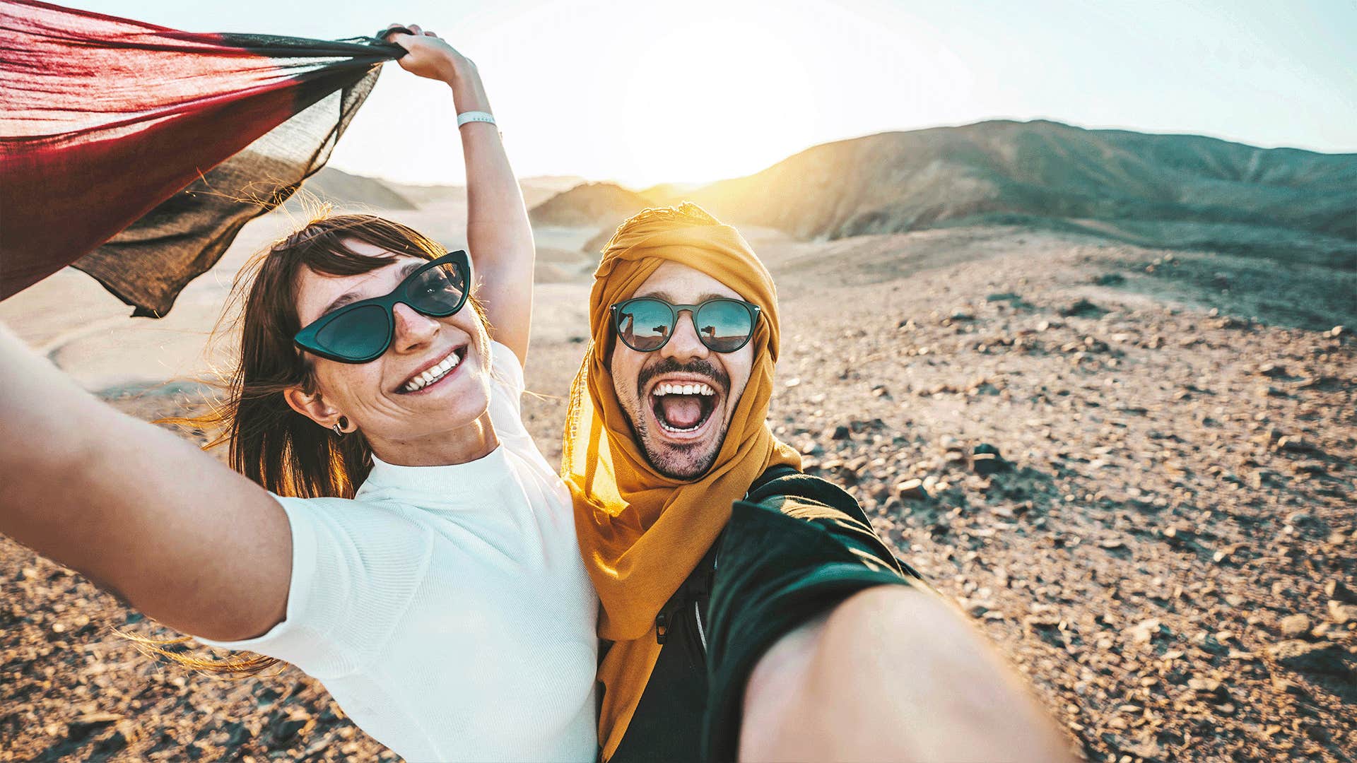 happy couple taking a selfie outdoors