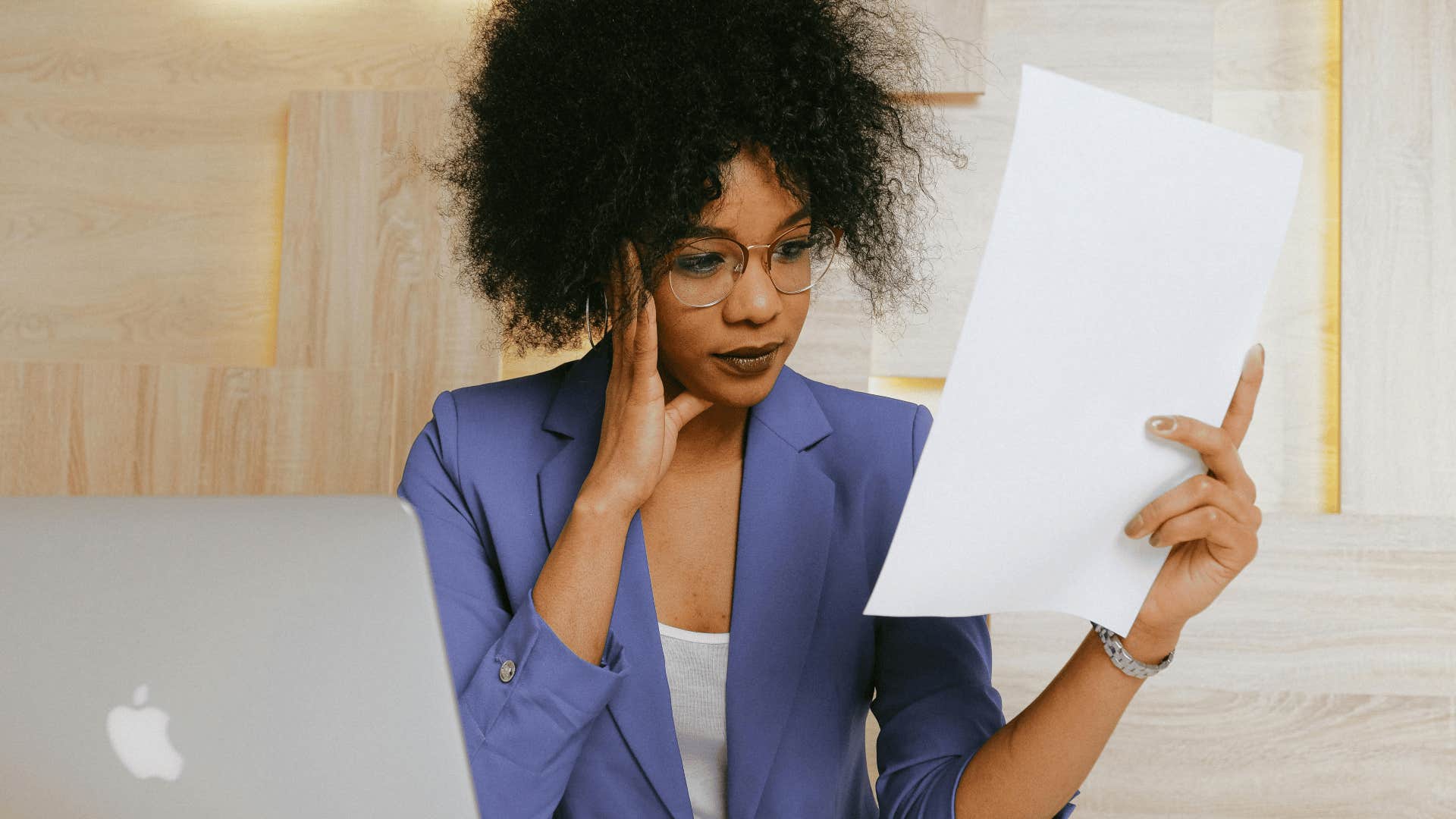 non-committal woman looking at paper