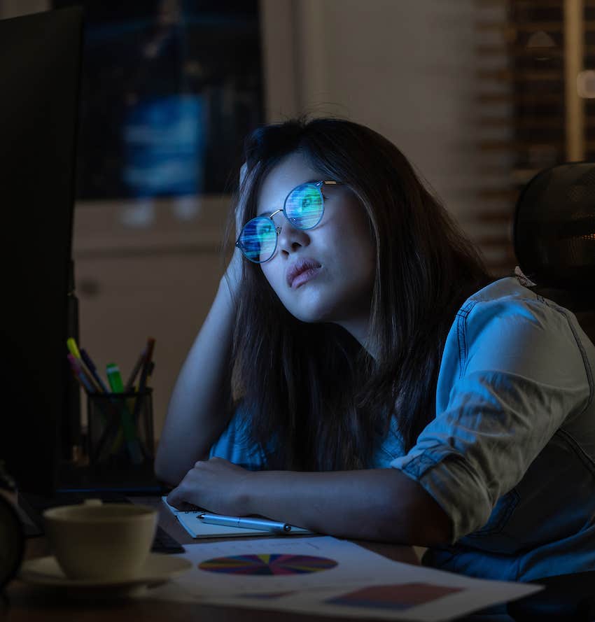 Woman stares blankly into screen as she read sadfishing posts