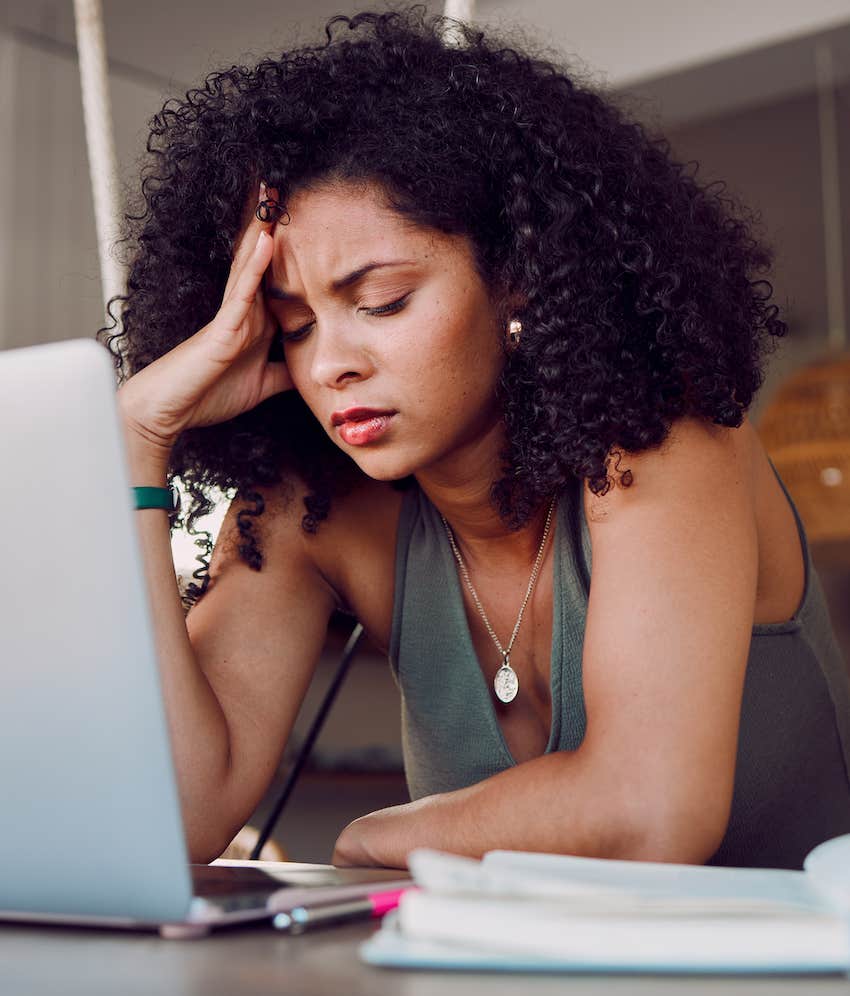 Stressed woman at computer looks like someone is sadfishing her