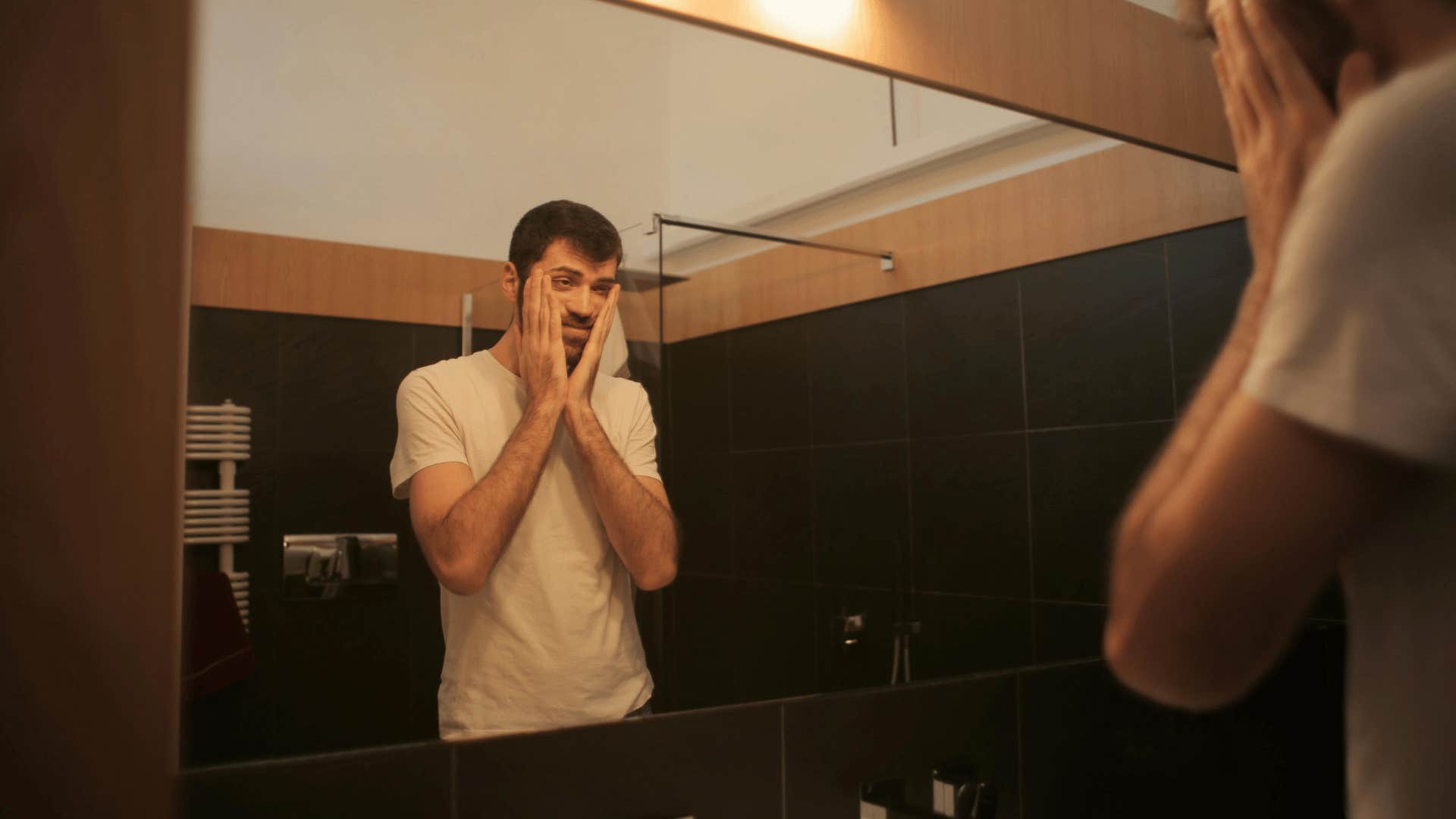 isolated man looking in mirror