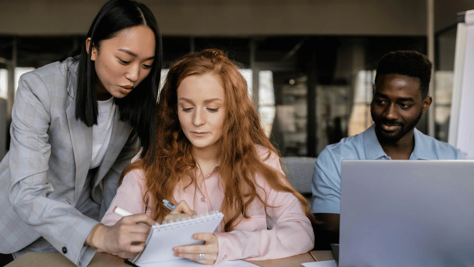 woman helping coworkers