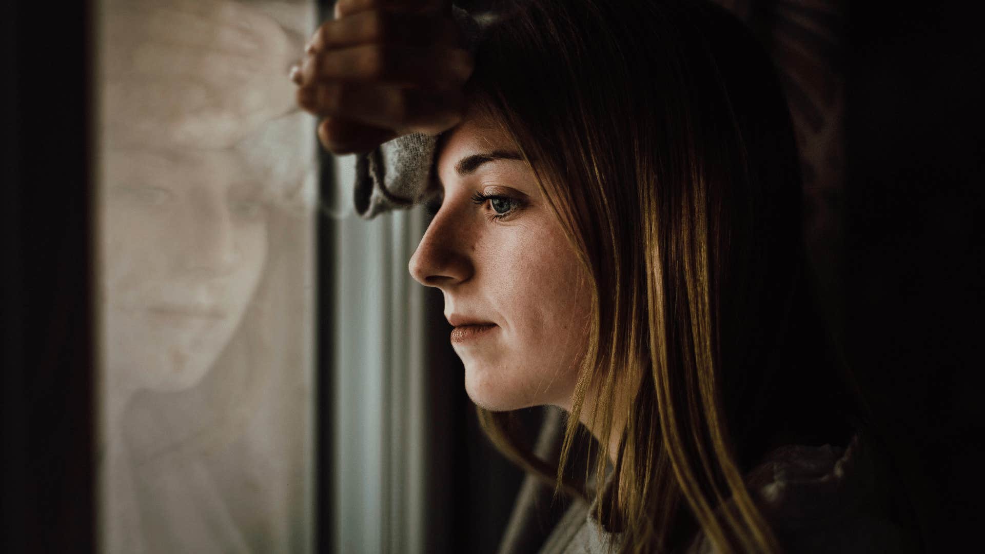 intelligent woman looking outside and thinking