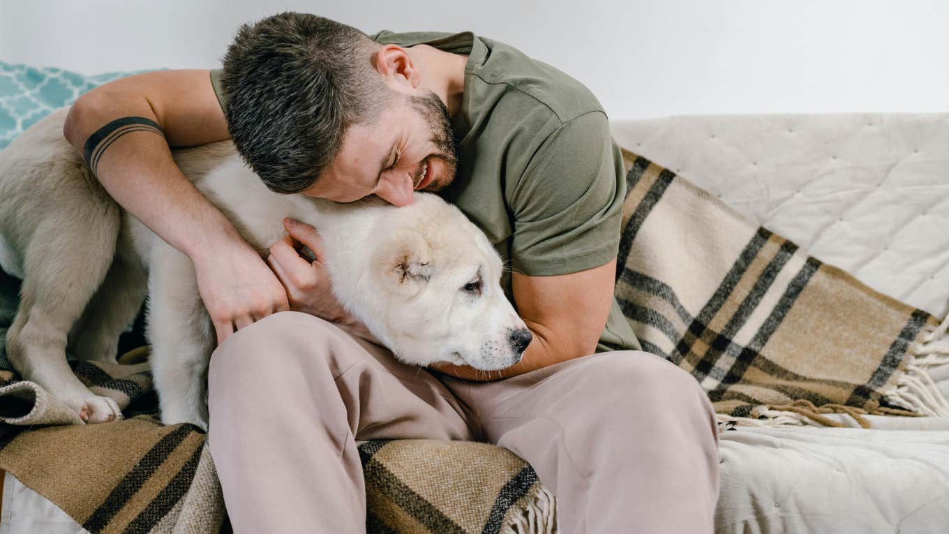 Single Dog Dad Says People Who Complain About Two Incomes Not Being Enough Are Probably Just Living Beyond Their Means man hugging his dog