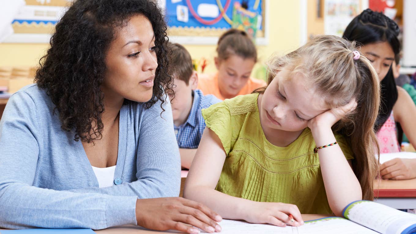 Student's Parents Want A Teacher To Document Everything teacher helping a student with assignment