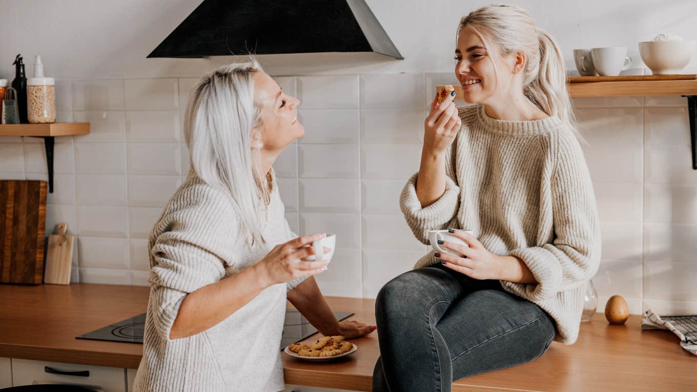 Teenage Girls Who Are ‘Nasty’ To Their Moms Have Secure Relationships Teenage girl sitting with her mother in the kitchen.