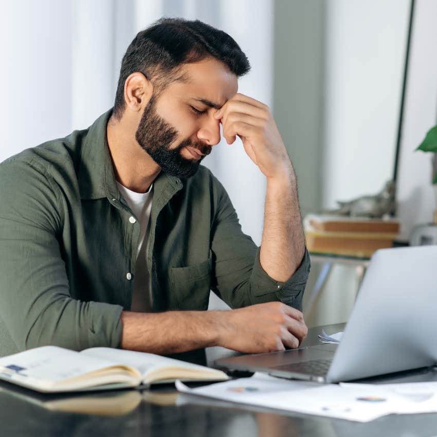 Tired corporate worker at his laptop. 