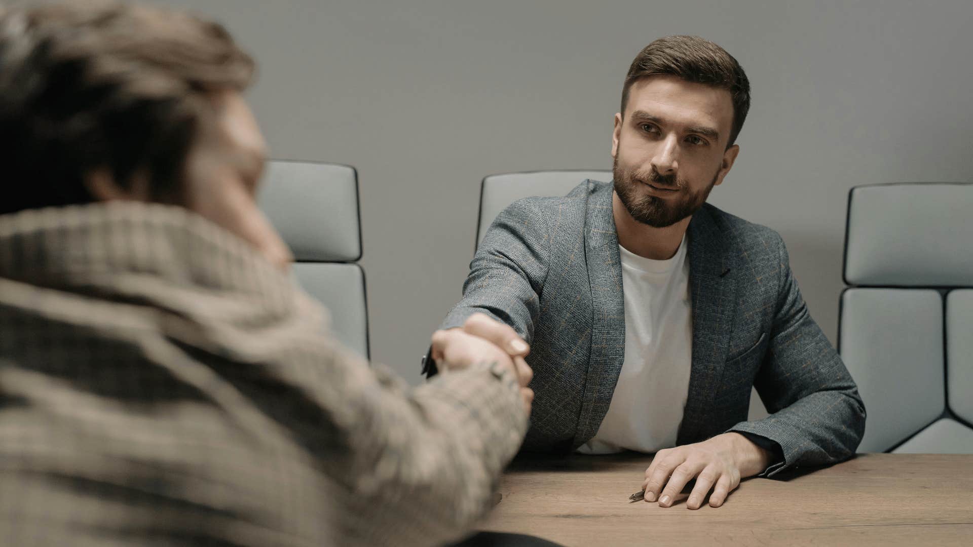 coworkers shaking hands agreeably